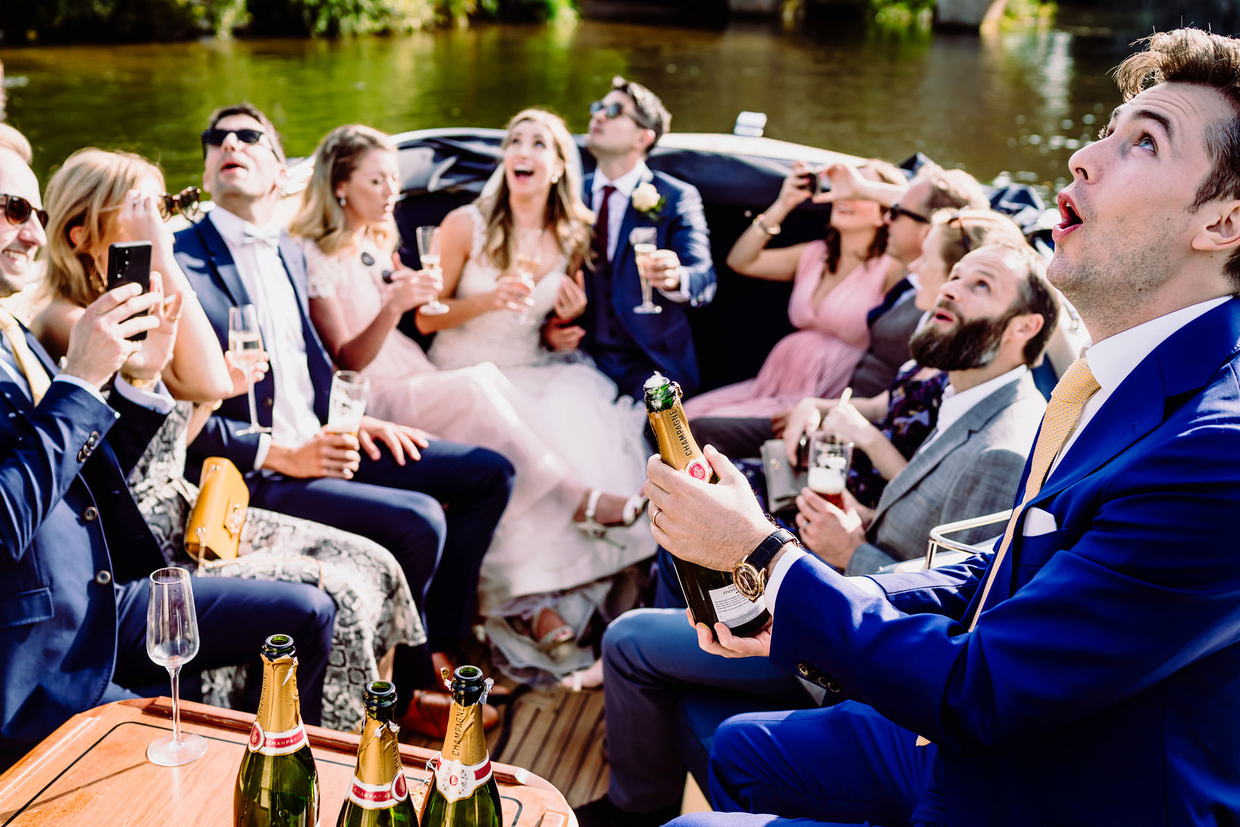 popping champagne at a wedding on the thames