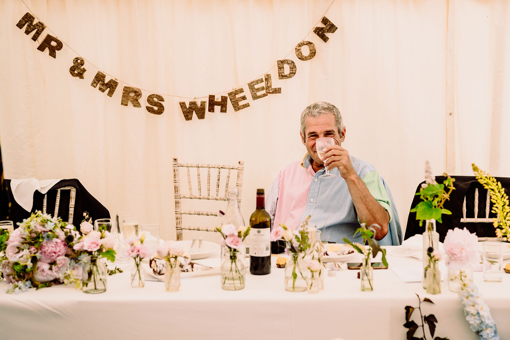 the father of the groom enjoying a drink