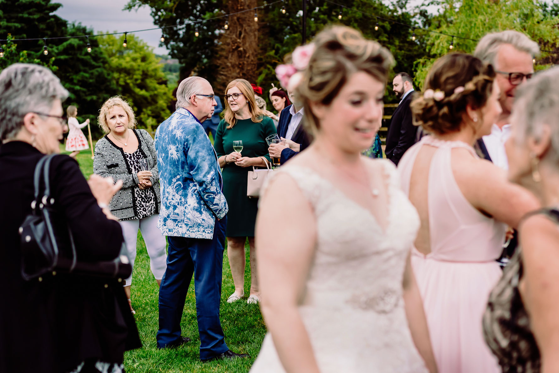 a wedding guest looks at the wedding dress